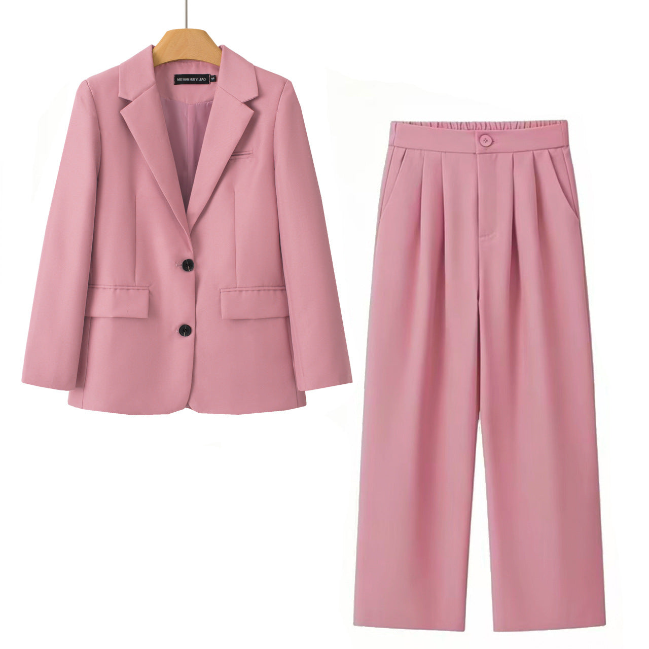 A women's two-piece clothing set in dusty pink, featuring a double-breasted blazer on a wooden hanger and matching wide-leg pleated trousers, displayed against a solid white background.