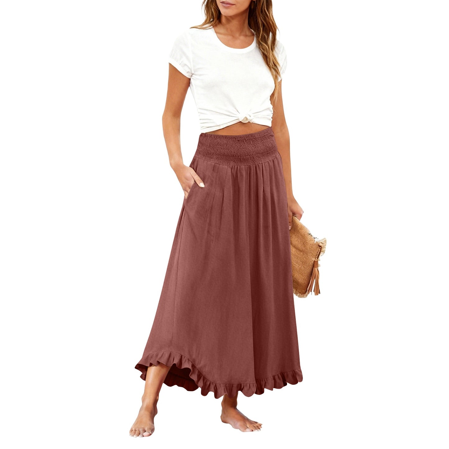 Woman wearing a white top and brown long skirt on a white background
