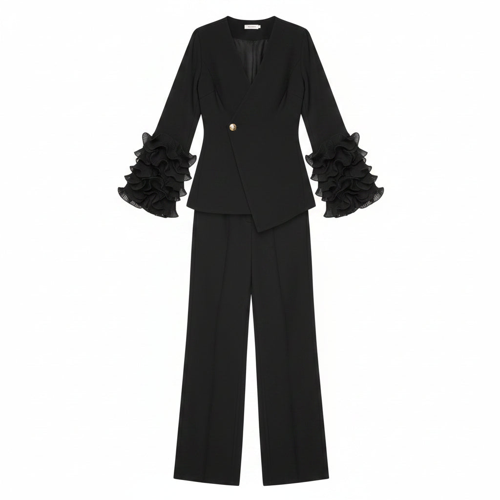 Person wearing a black outfit with ruffled sleeves in a room with a plant and mirror.
