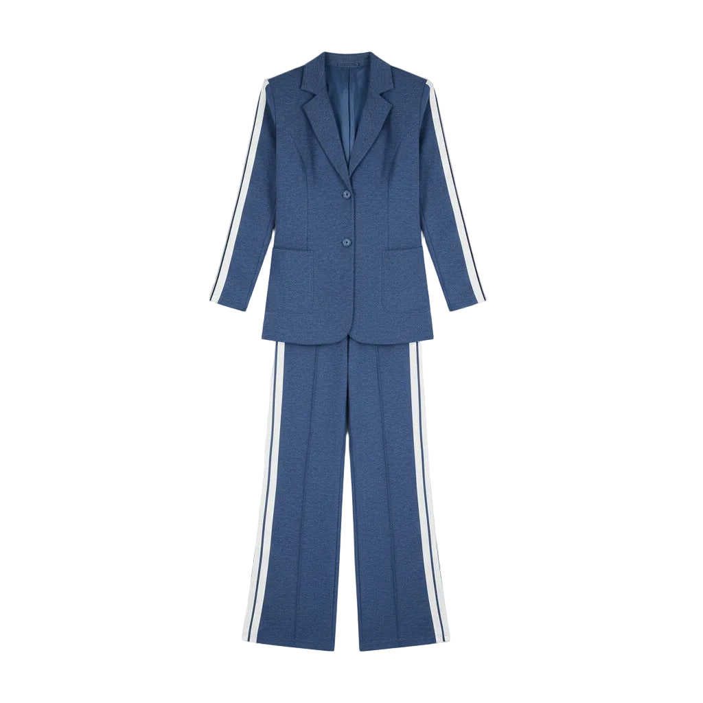 Woman in a blue suit with white stripes standing in front of a wardrobe.