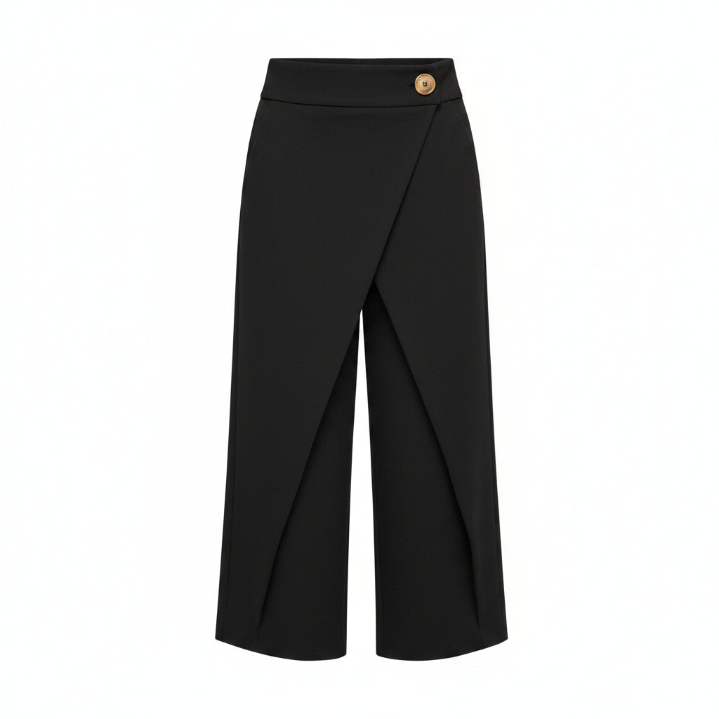 Black wide-leg pants worn with a white shirt on a gray background