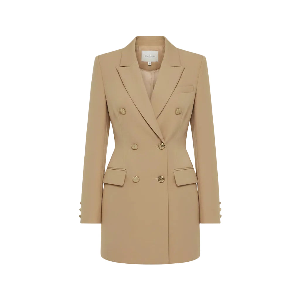 Woman wearing a beige blazer dress in an outdoor setting