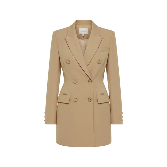 Woman wearing a beige blazer dress in an outdoor setting