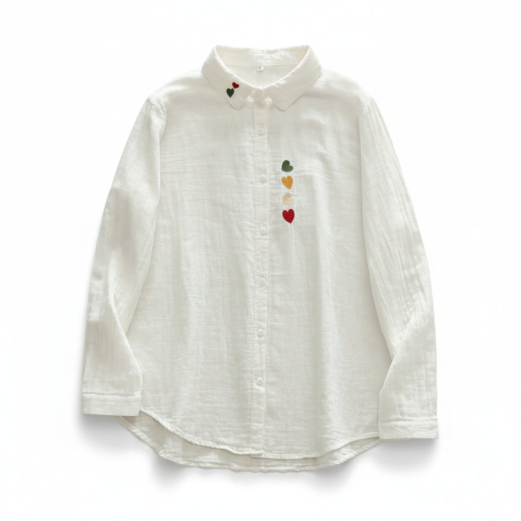 White shirt with colorful heart designs on a wooden surface
