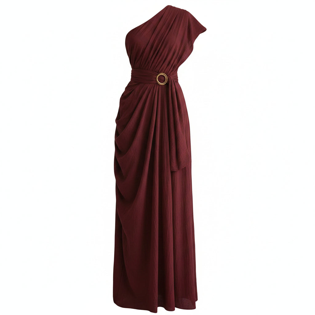 Woman wearing a burgundy one-shoulder dress against a beige wall.