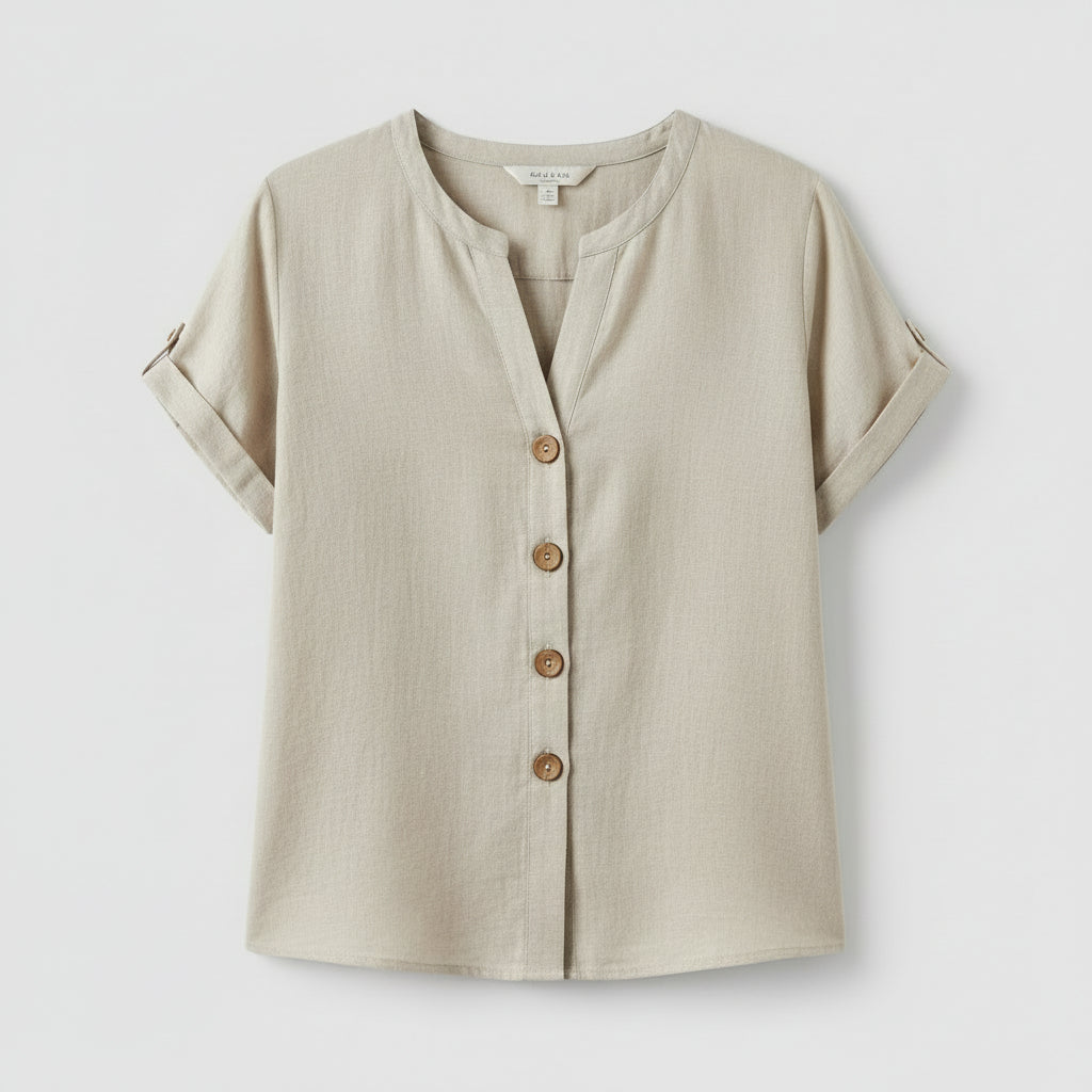 Woman wearing a light-colored button-up shirt with a neutral background