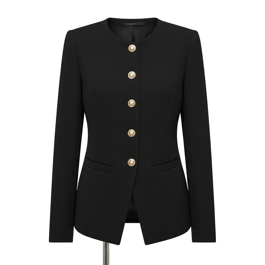 A woman wearing a black long-sleeve blazer with a row of decorative silver buttons down the front, paired with black pants and a gold chain necklace.