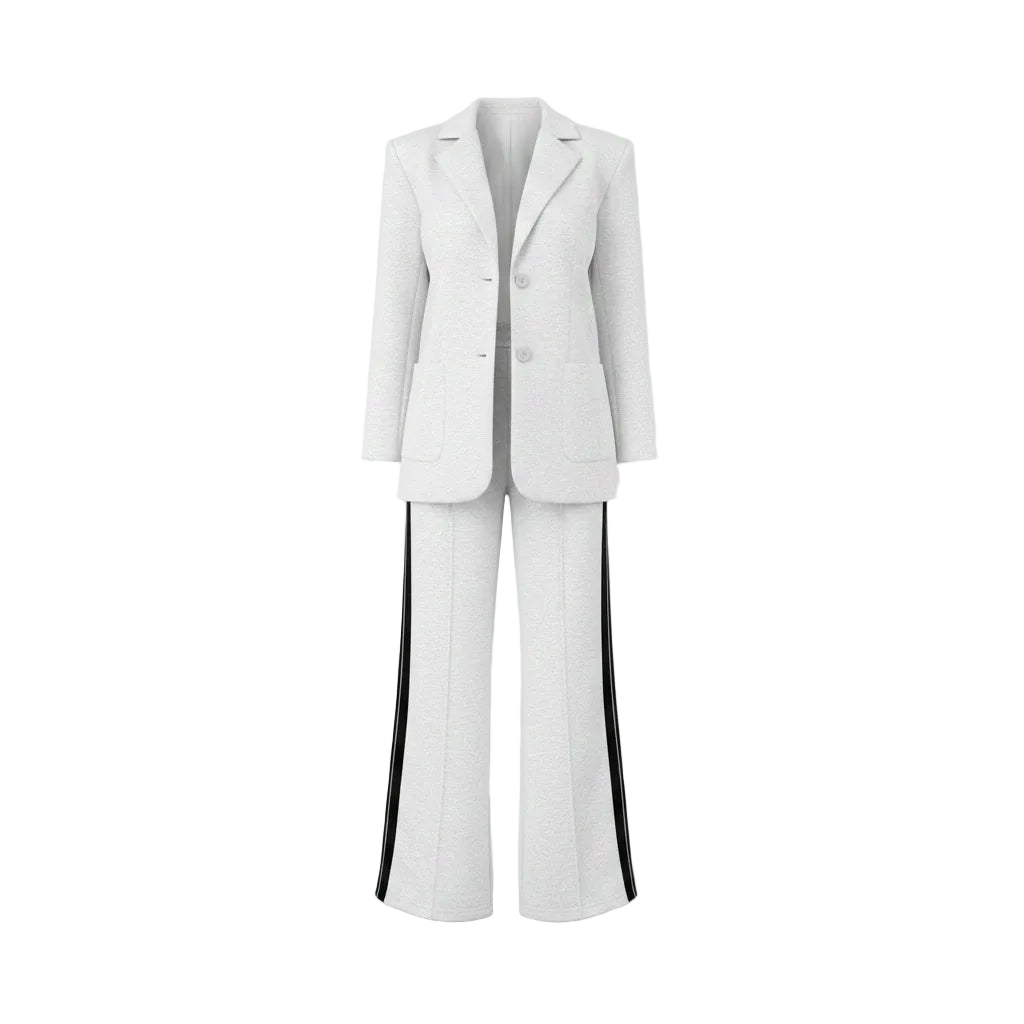 Woman in a white outfit with black stripes standing in a wardrobe.