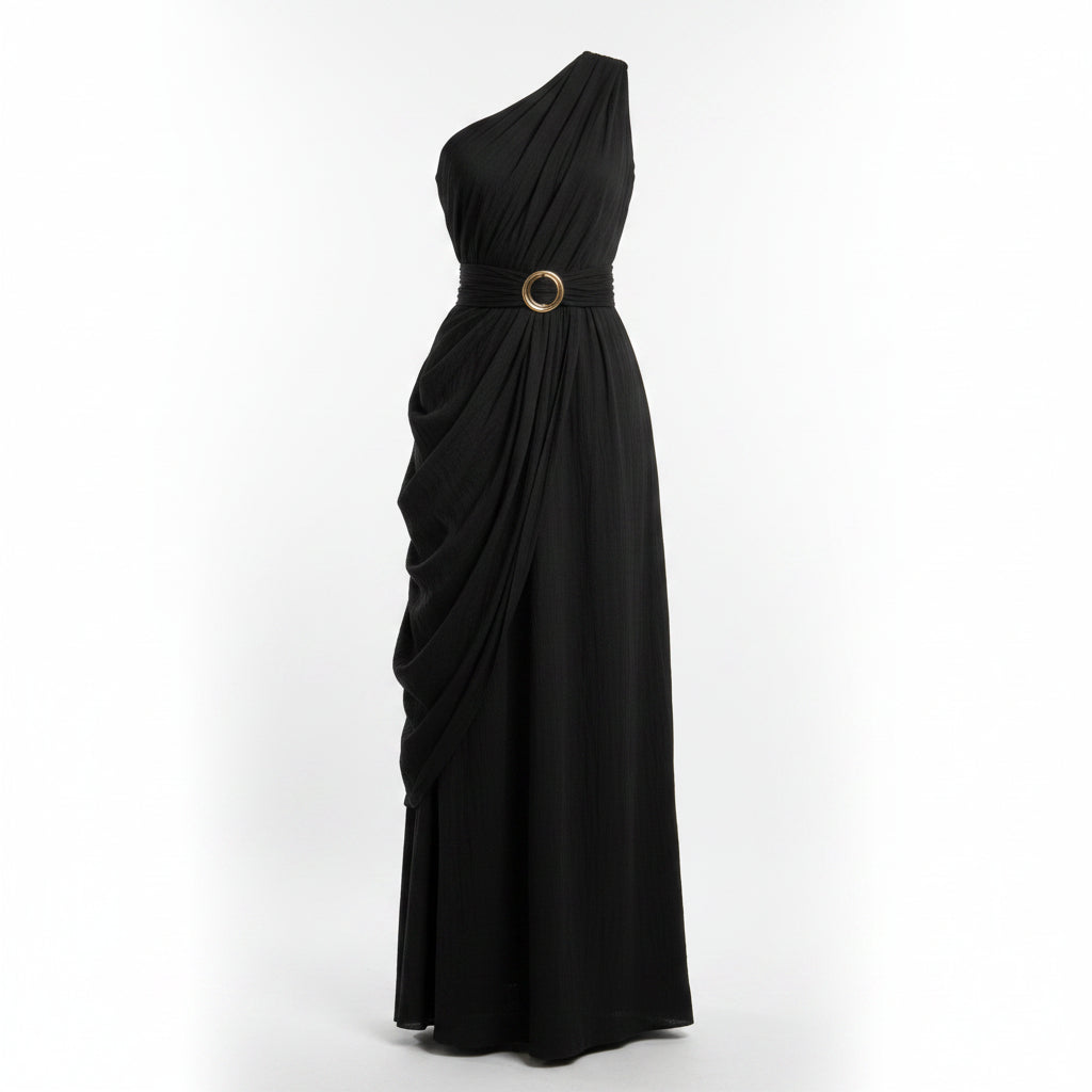 Woman wearing a black one-shoulder dress against a beige wall