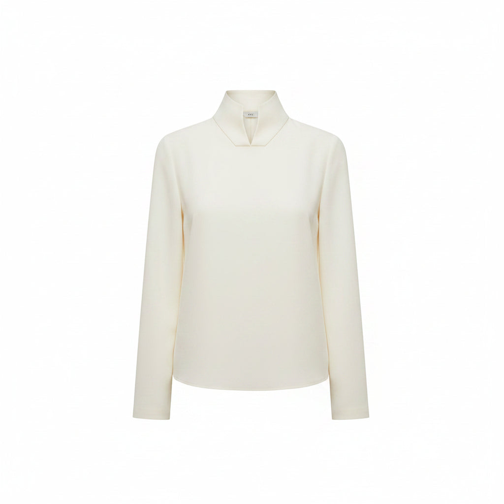 Person wearing a white long-sleeve top and pants with a blurred background