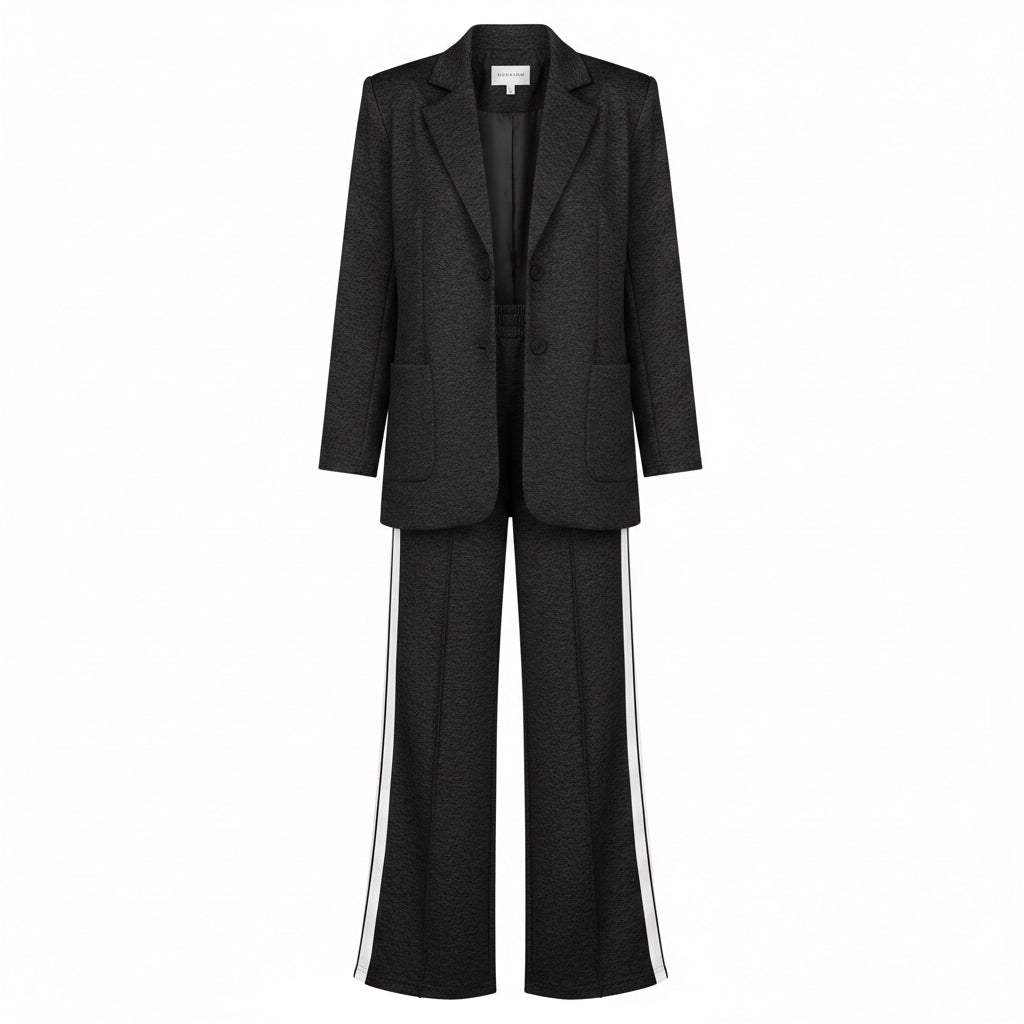 Woman in a black suit with white stripes standing in a closet.